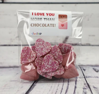 Chocolate hearts in a bag. Sticker saying "I love you more than chocolate"